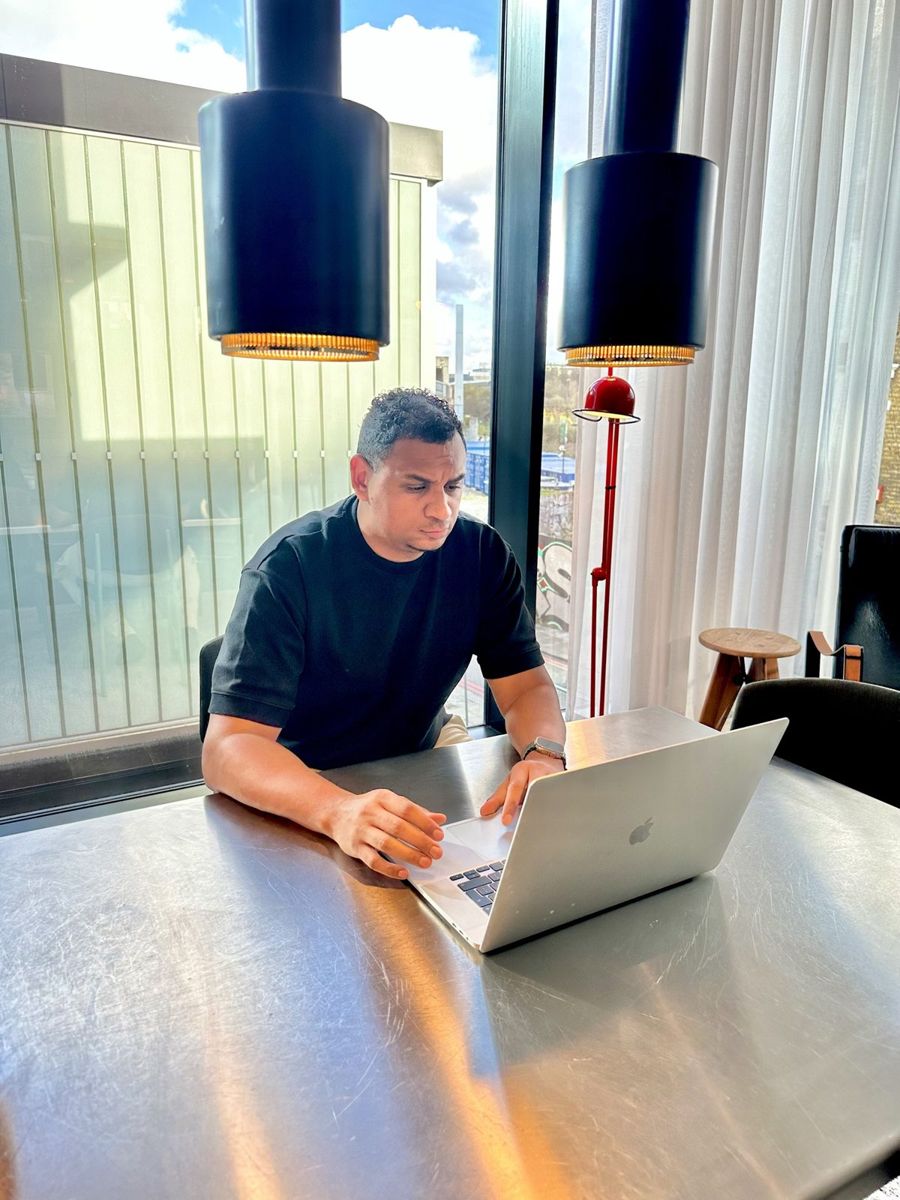Shayne Williams working at a table by the window